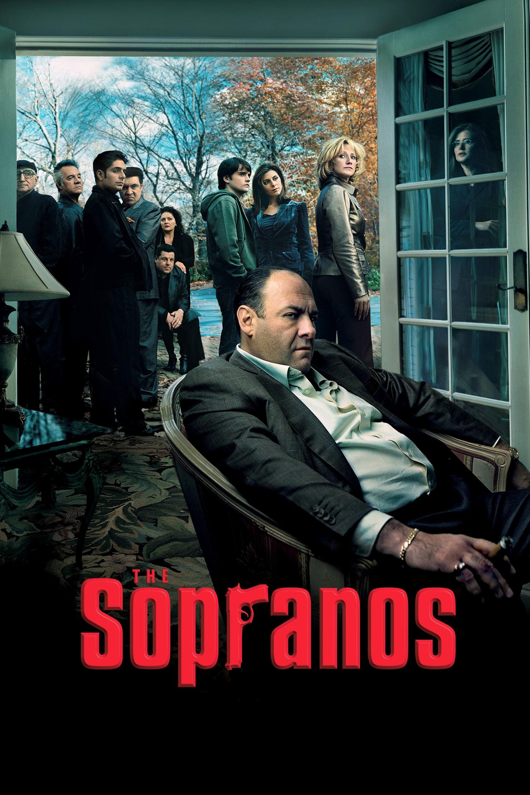 A man sits in an armchair indoors, looking serious, while a group stands outside on a patio. The moody scene, set against autumn trees, features The Sopranos title in bold red with an IPTV Latino overlay.